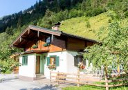 Modern Accommodation in Kaprun, Surrounded by Green Mountain Scenery and Flowers.